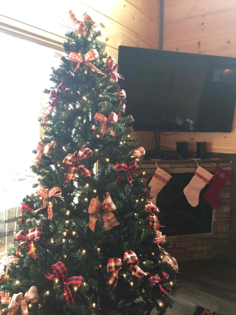 Gatlinburg Christmas tree with stockings on the mantle