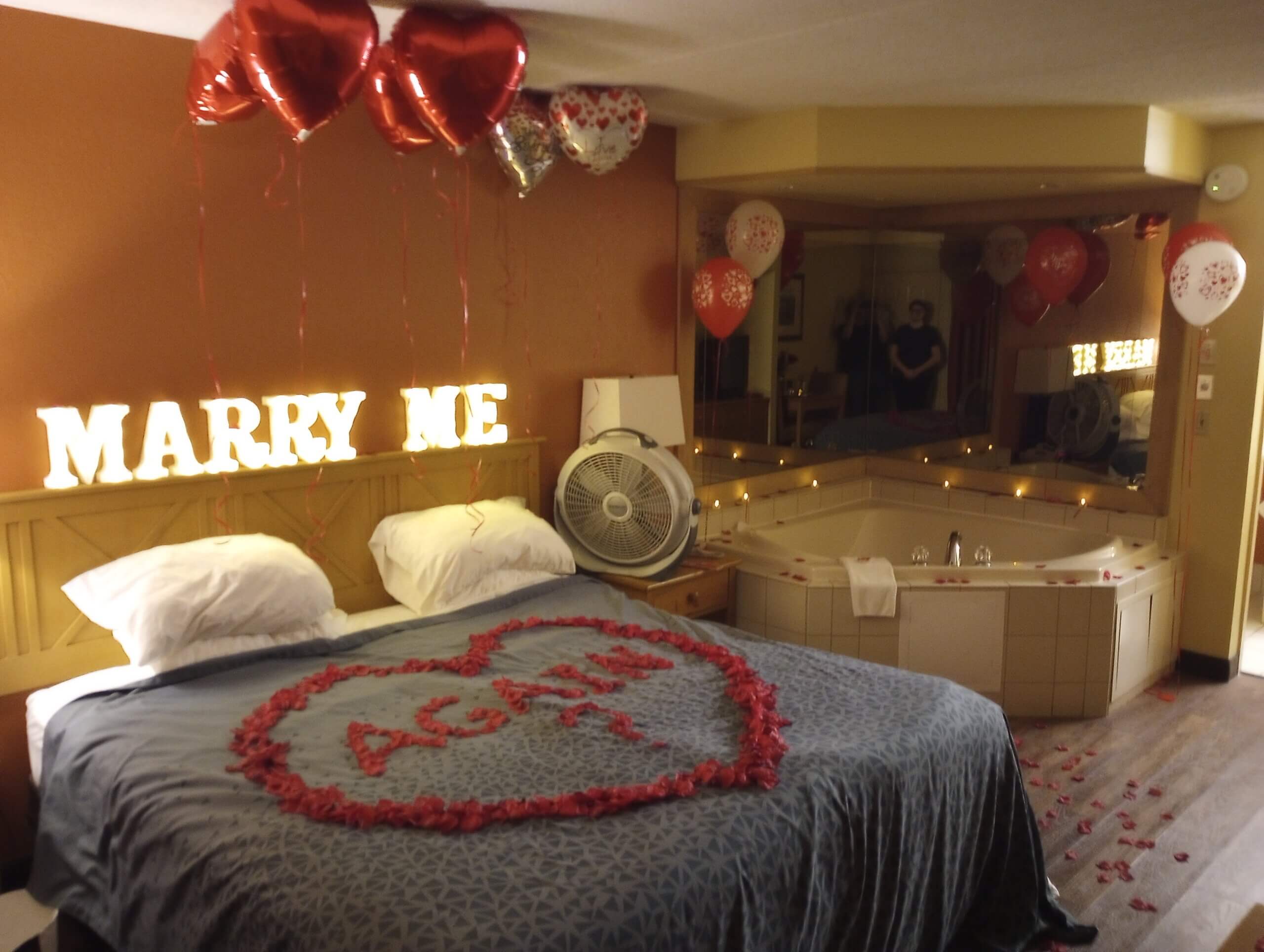 marry me lit letters with balloon ceiling and romantic rose petal heart